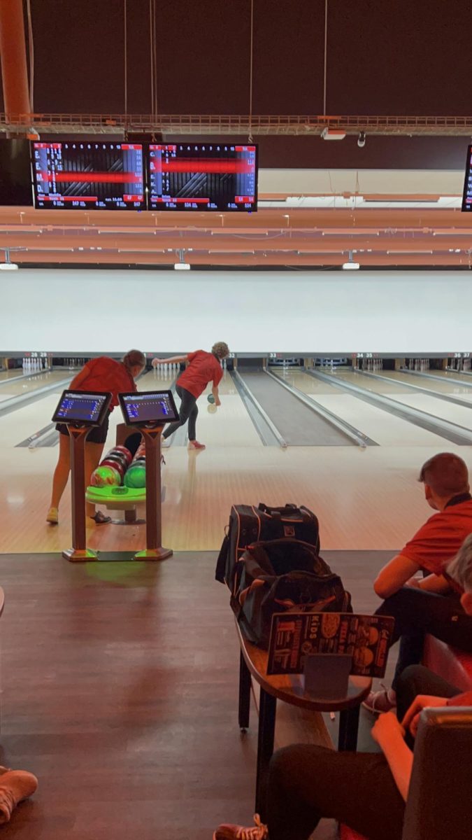 Sophomore Brian Strohman rolls for a strike in a recent bowling match. He is juggling two sports; bowling and hockey.