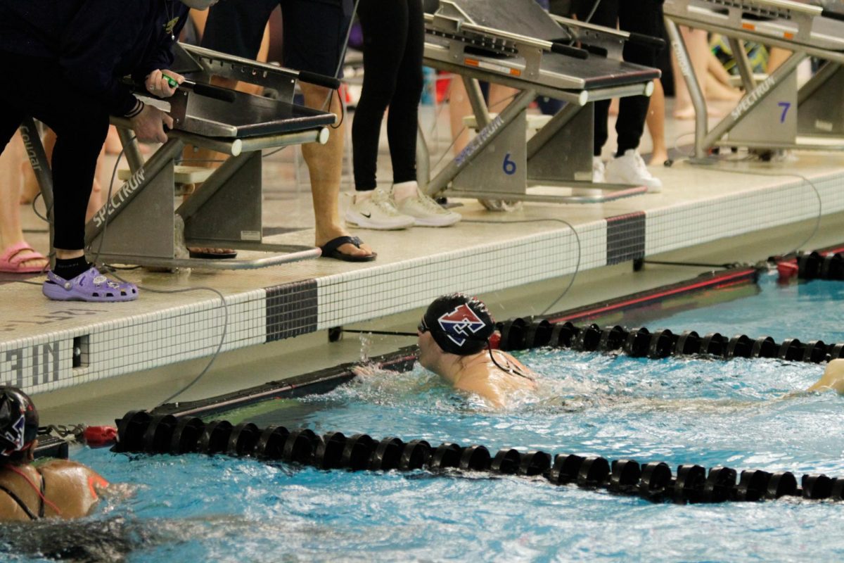 Sophmore Maria Visquert-Fuentes reaches for the wall as she finishes her laps 