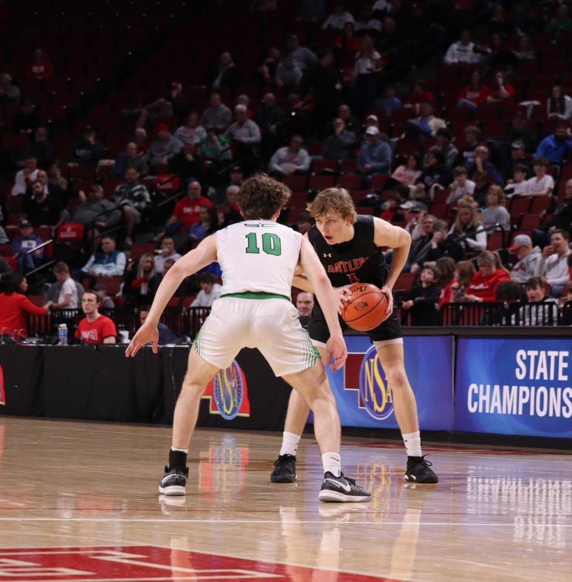 Senior Colin Comstock picks up his dribble to pass the ball. Antlers lost to Skyhawks 61 to 69 in the State Quarter Finals.