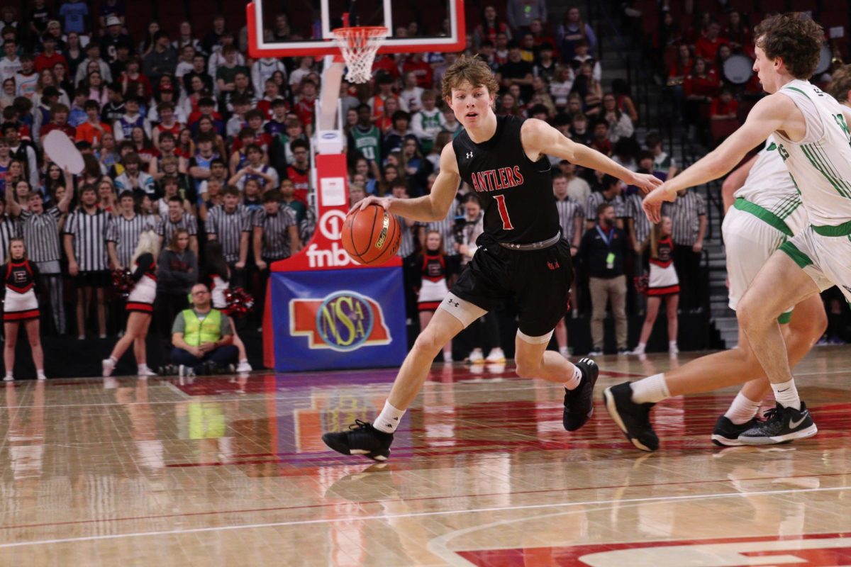 Senior Colin Comstock dribbles down to the end of the court. Antlers lost to Skyhawks 61 to 69 in the State Quarter Finals.