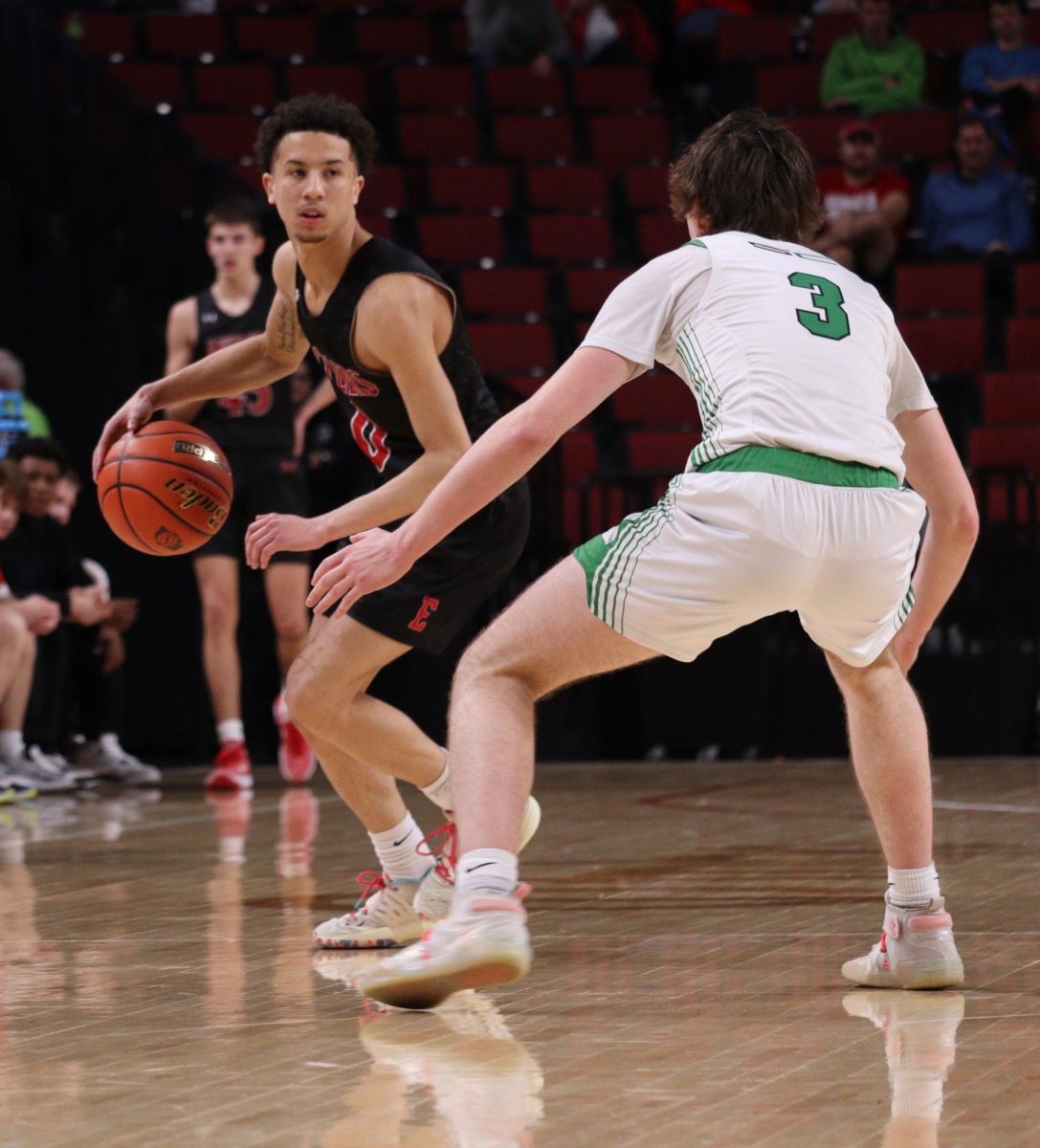 Senior Luke Howard attempts to dribble past Skyhawk Junior Kyle Cannon. Antlers lost to Skyhawks 61 to 69 in the State Quarter Finals.