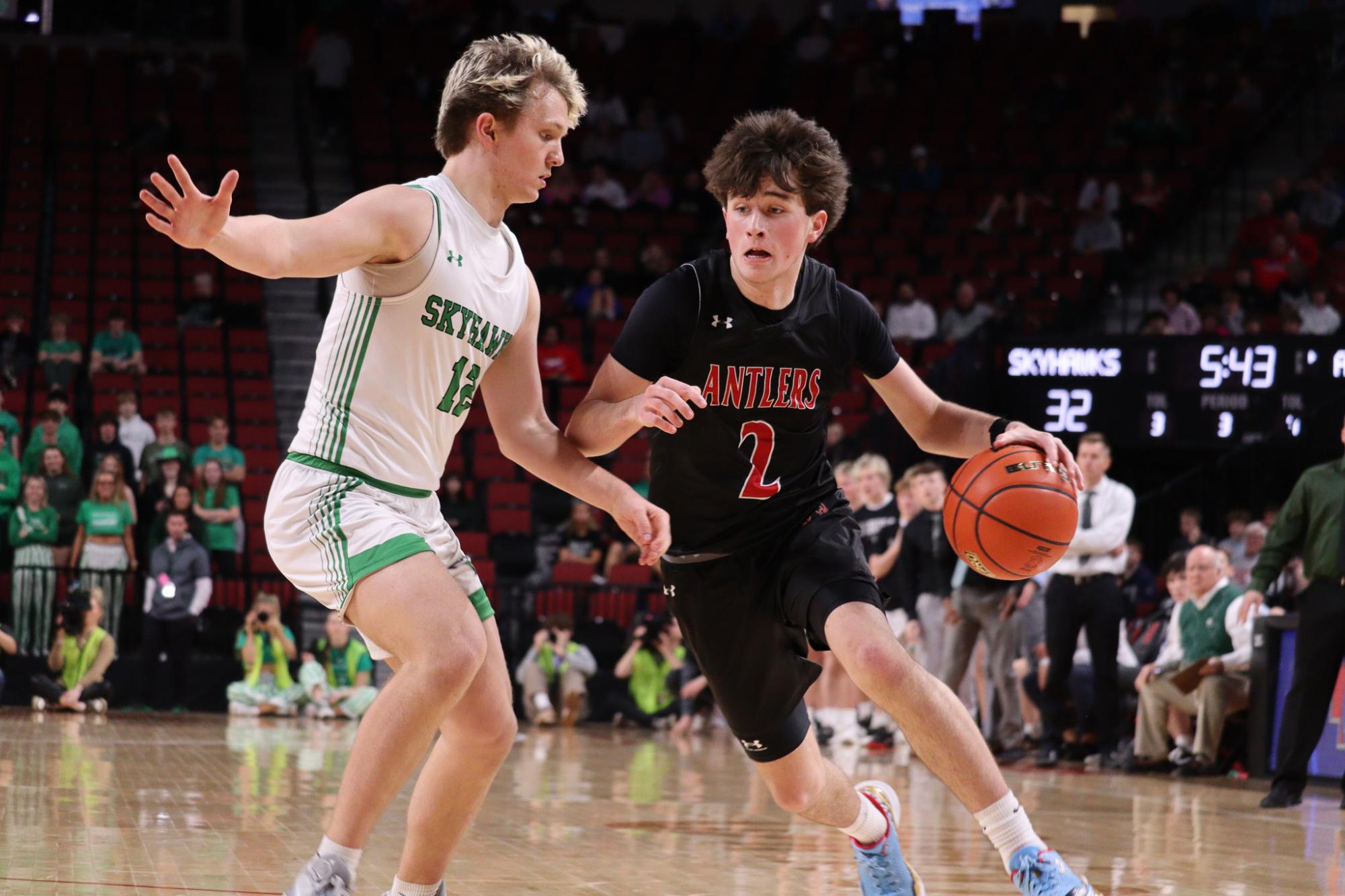 Junior Nixon Farmer dibbles past the Skyhawk defender. Antlers lost to Skyhawks 61 to 69 in the 2023 State Quarter Finals.