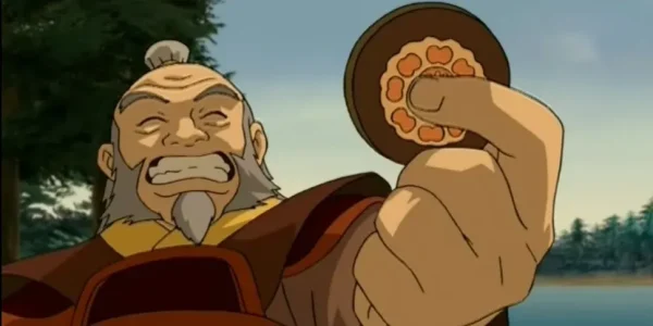 Uncle Iroh is holding the infamous white lotus piece, a clever bit of foreshadowing that is not obvious.
Photo courtesy: CinemaBlend