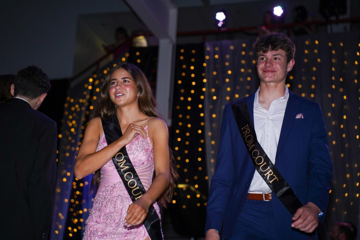 Juniors Olivia Bailey and Charlie Lamski walk through the crowd to get to the stage.