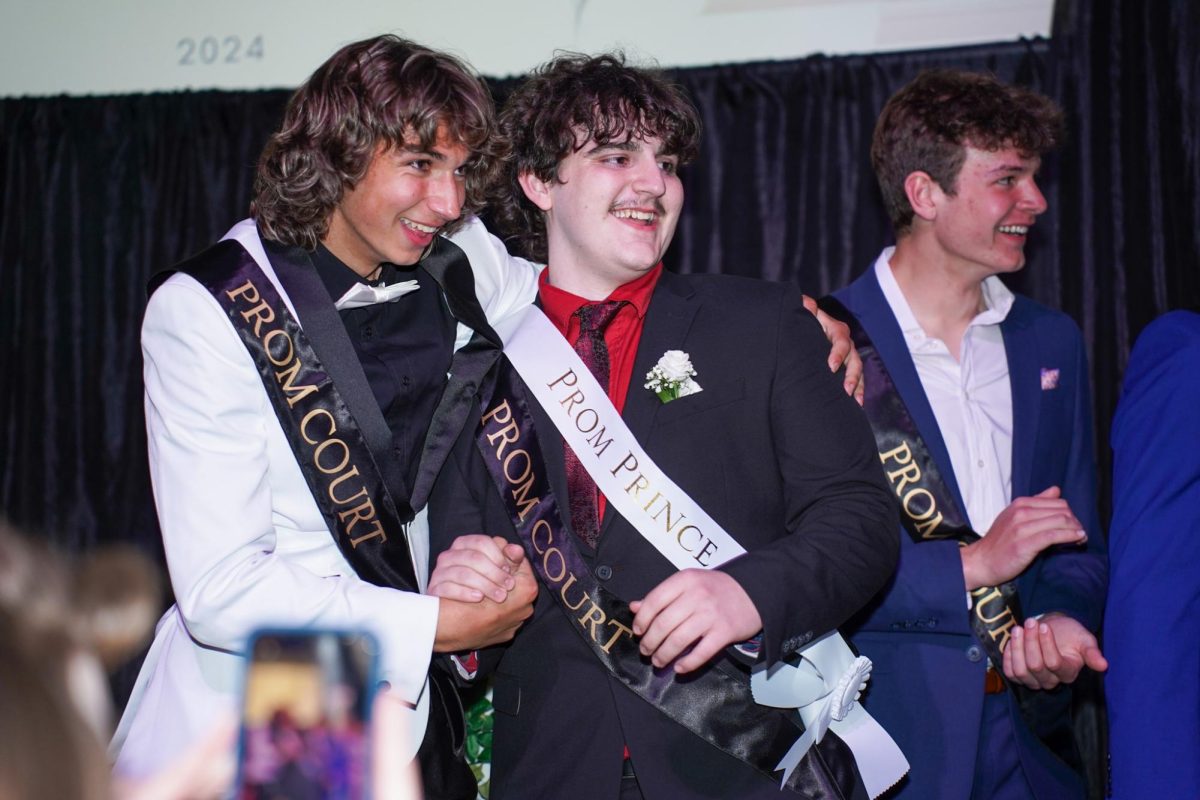 Juniors Nick Pagliuca and Tim Boomgarden share a handshake after Tim is announced the Prom Prince. 