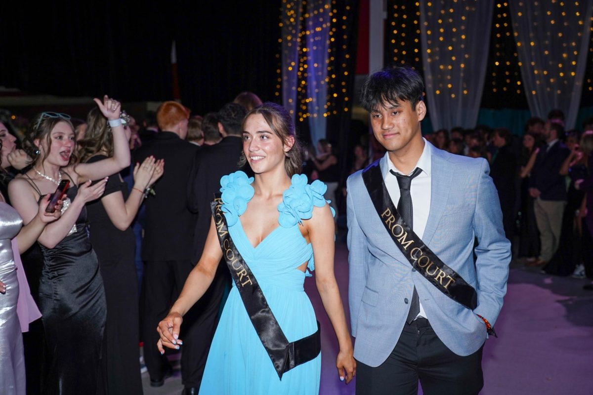 Seniors Paulina Fomicheva and Phillip Truong make their way through the cheering crowd. 