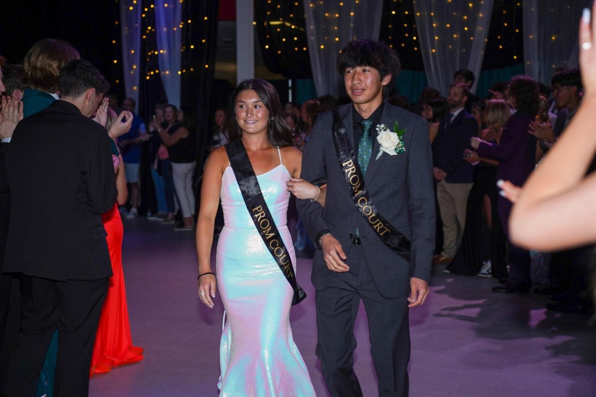 Seniors Ava Kumagai and Kaito Hoori walking to the stage. 