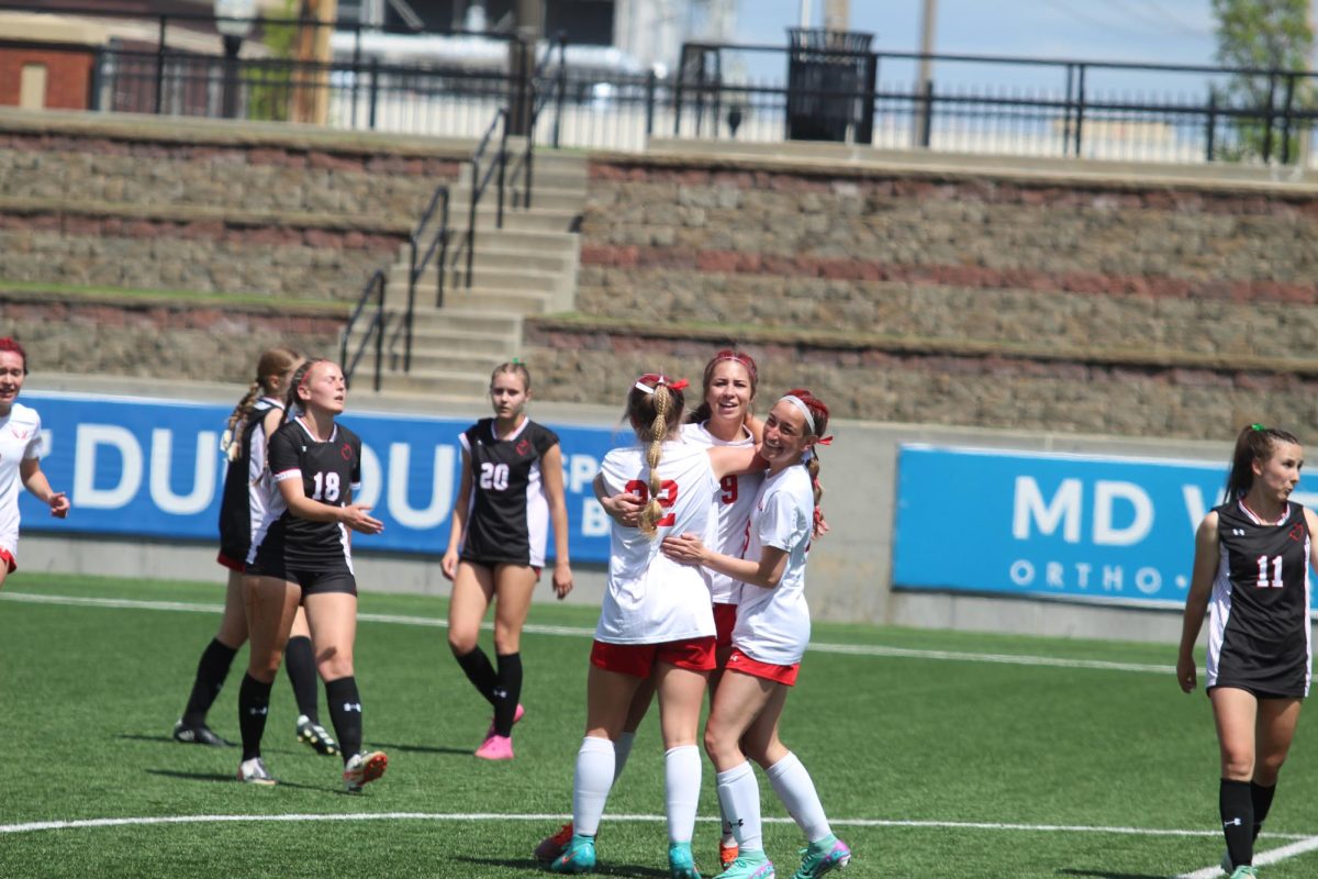 Junior Becca Leise and sophomore Olivia Thompson celebrate junior Olivia Baileys second goal of the game. The Antlers lost 3-2 to Duchesne at the NSAA state tournament on Wednesday, May 8th.