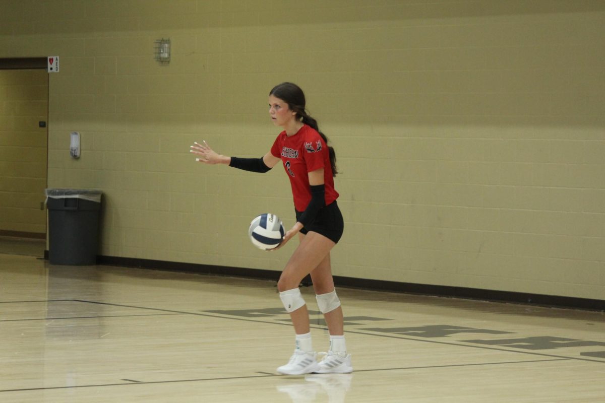 Sophomore Kaiya Gilbert serves the ball to the Storm. The Antlers lost to the Storms in the Volleyball Jamboree.