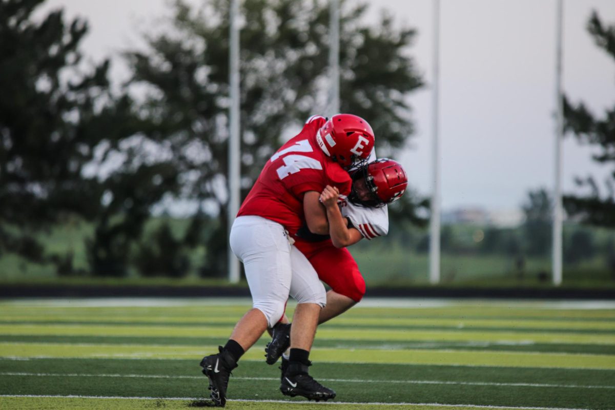 Senior Timothy Boomgarden attempts to tackle a JV player during the Gatorade scrimmage.