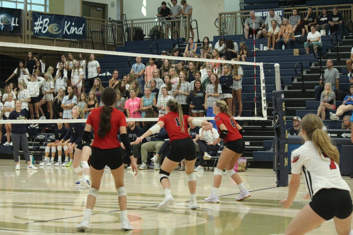 Seniors Addie Hunt and Ava McCaslin prepare to block the opponents ball. The Antlers lost to the Storm in the Volleyball Jamboree.