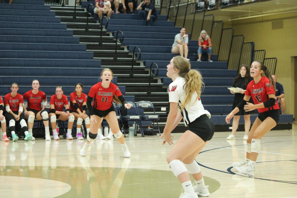 Senior Macie Burson and sophomores Bailey Ferguson and Parker Steskal call for the ball. The Antlers lost to the Storm in the Volleyball Jamboree.