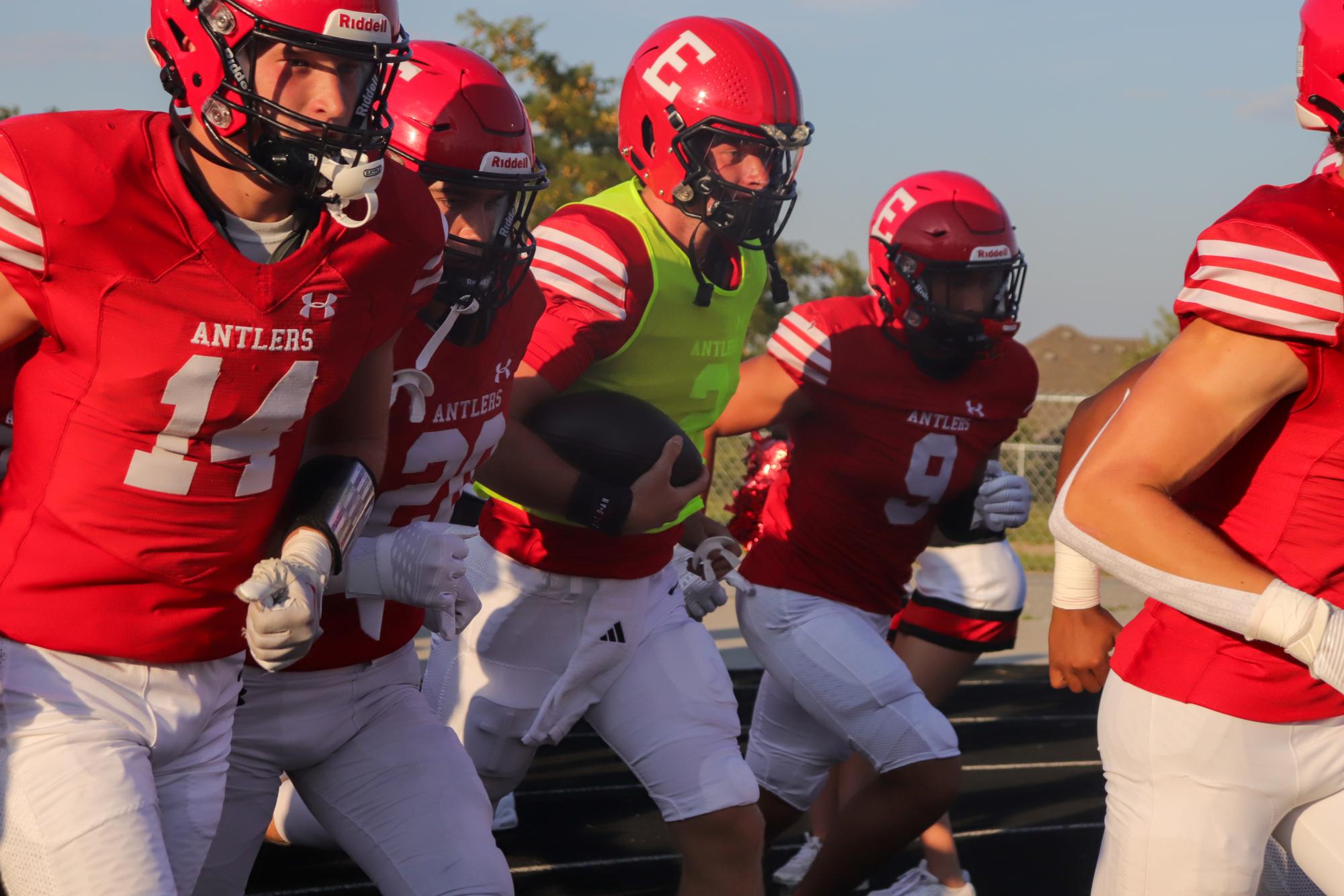 The Red Team runs out of the locker rooms to play the game. This took place during the annual red/white scrimmage. 