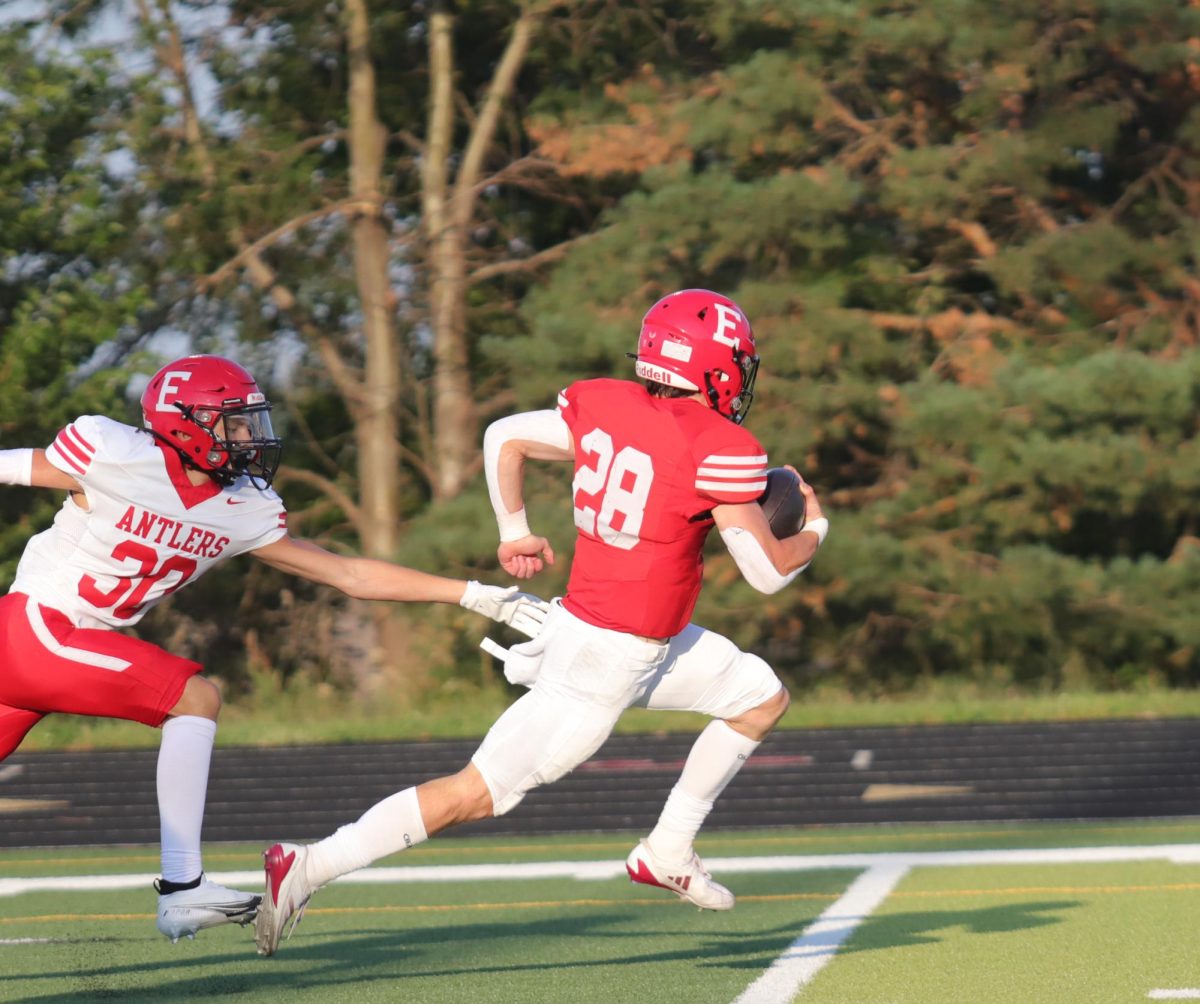 Senior, Elliot Beister, running away from the White Team so that he can score. This took place during the annual red/white scrimmage. 