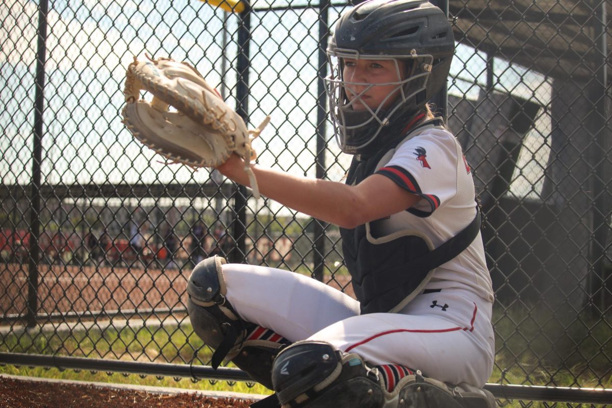 JV and Varsity swinger, Kinsley Coleman, gets ready to catch a pitch. She is helping pitcher Samantha Michaud warm up for the JV game against Waverly.