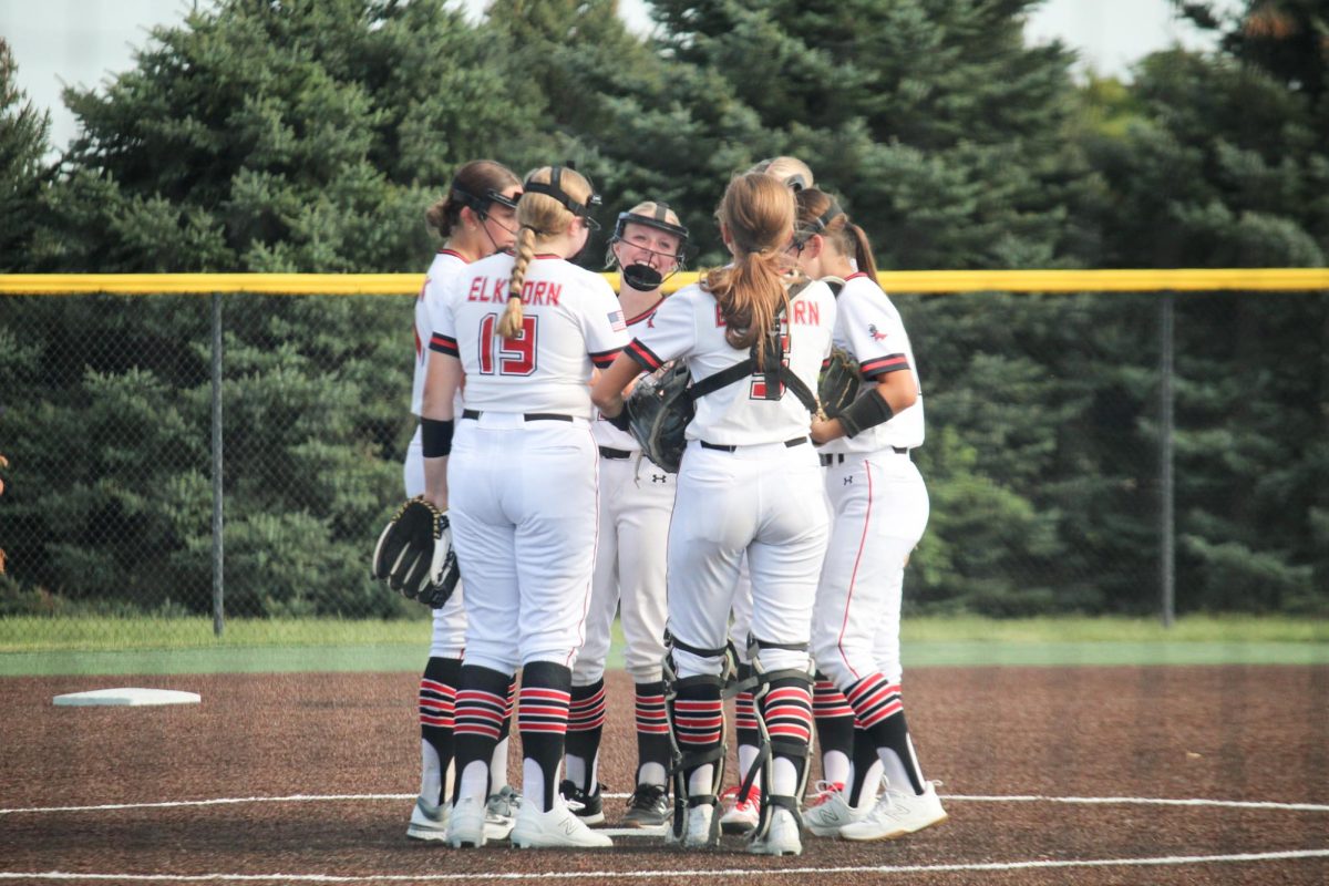 The JV girls have a meeting at the mound. This picture took place at the JV game versus Waverly.