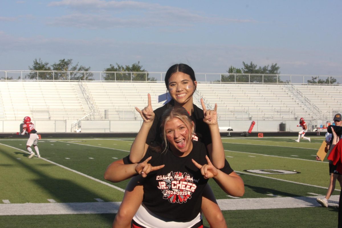 Senior Lauren Vermeeren and freshman Jasmin _____ cheer at the red white scrimmage. The cheer team celebrated their annual Jr Cheer Clinic during the football game on August 22nd. 