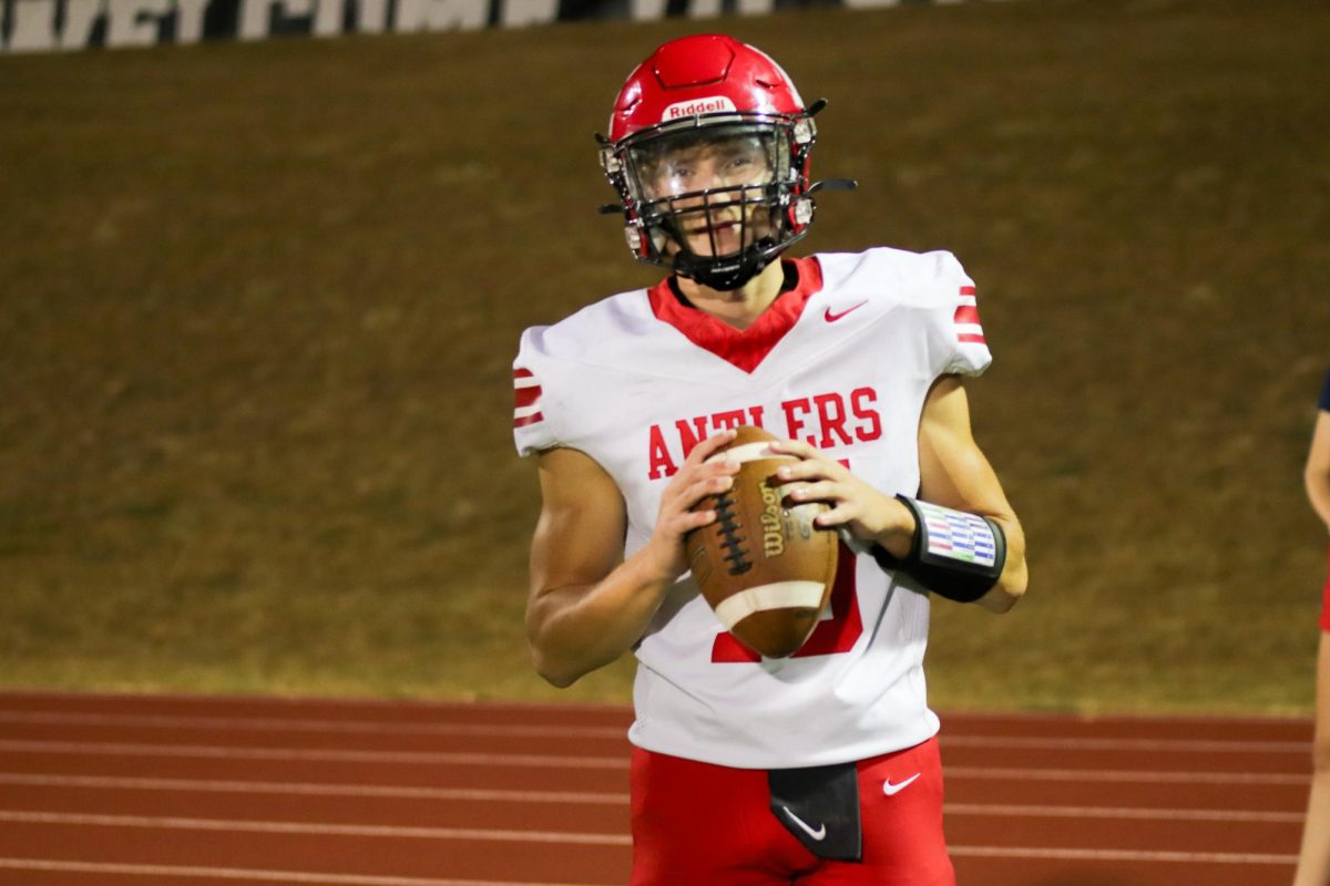 Junior Aiden Zelasney is warming up his teammates before the next play. The final score for varsity football on 9/20 was 0-28 Waverly.