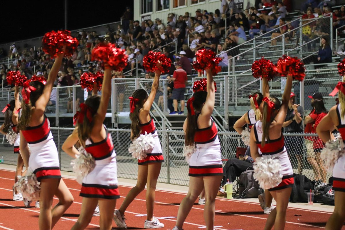 The cheerleading team pumps up the crowd.  The final score for varsity football on 9/20 was 0-28 Waverly.