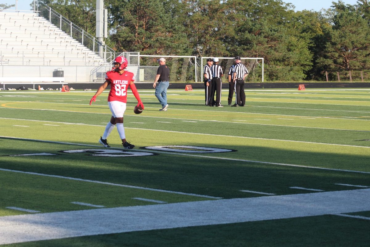 Trey Pacas punts the ball and warms up before the game.  The JV football team beat Blair with a final score of 21 - 0.