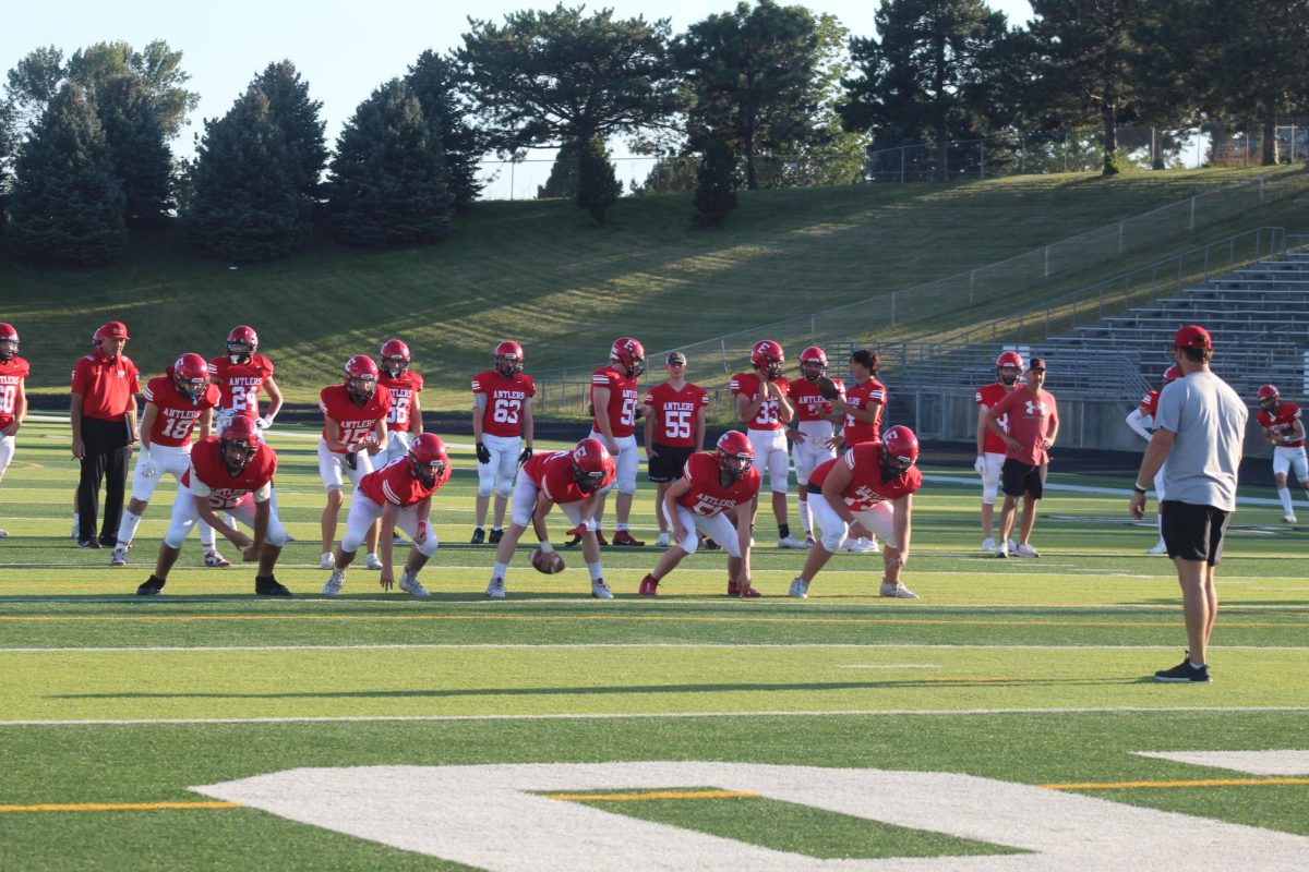 The JV line practices before the game starts.  The JV football team beat Blair with a final score of 21 - 0.