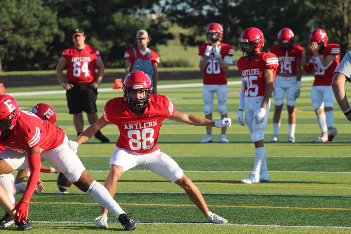 Brody Clevenger practices plays before the game starts.  The JV football team beat Blair with a final score of 21 - 0.