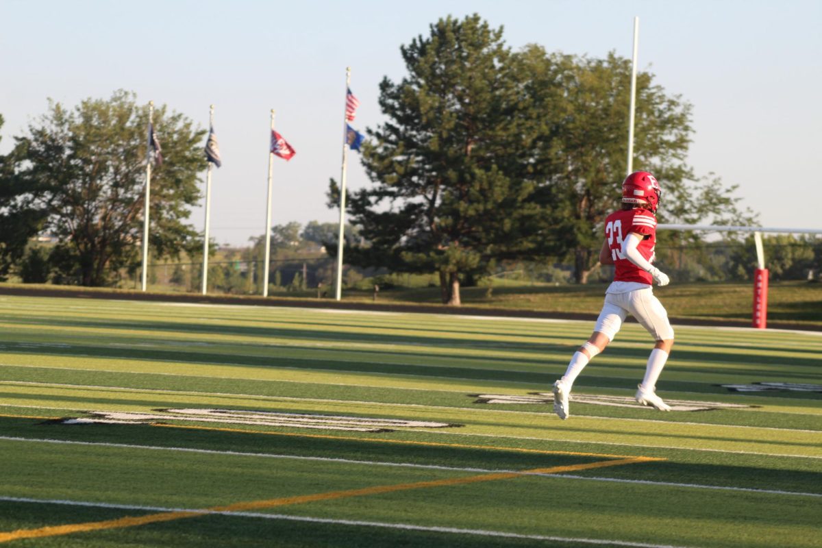 Brayden Durant runs off the field celebrating a play.  The JV football team beat Blair with a final score of 21 - 0.