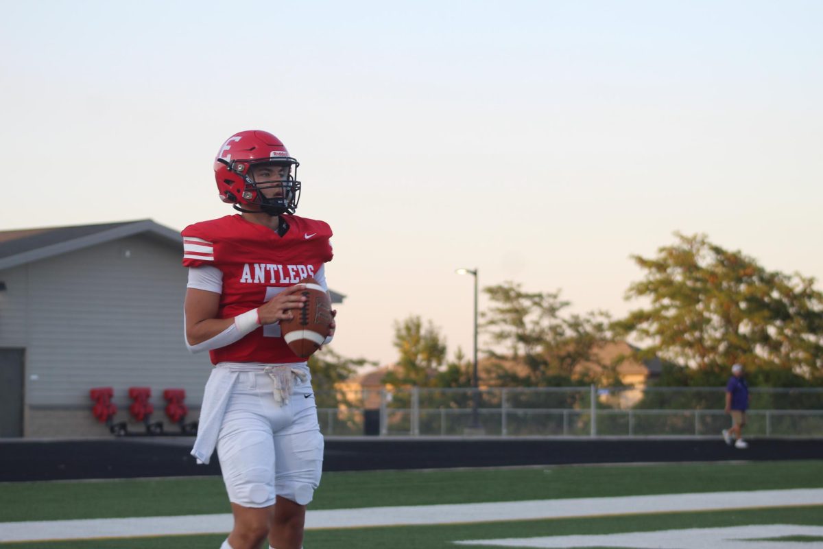 Baron Clevenger warms up during halftime.  The JV football team beat Blair with a final score of 21 - 0.