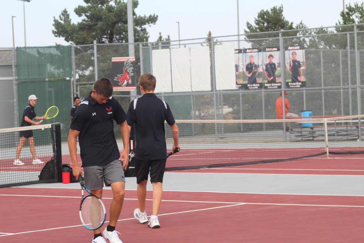 Senior, John Karnett, walking back to get ready to serve.