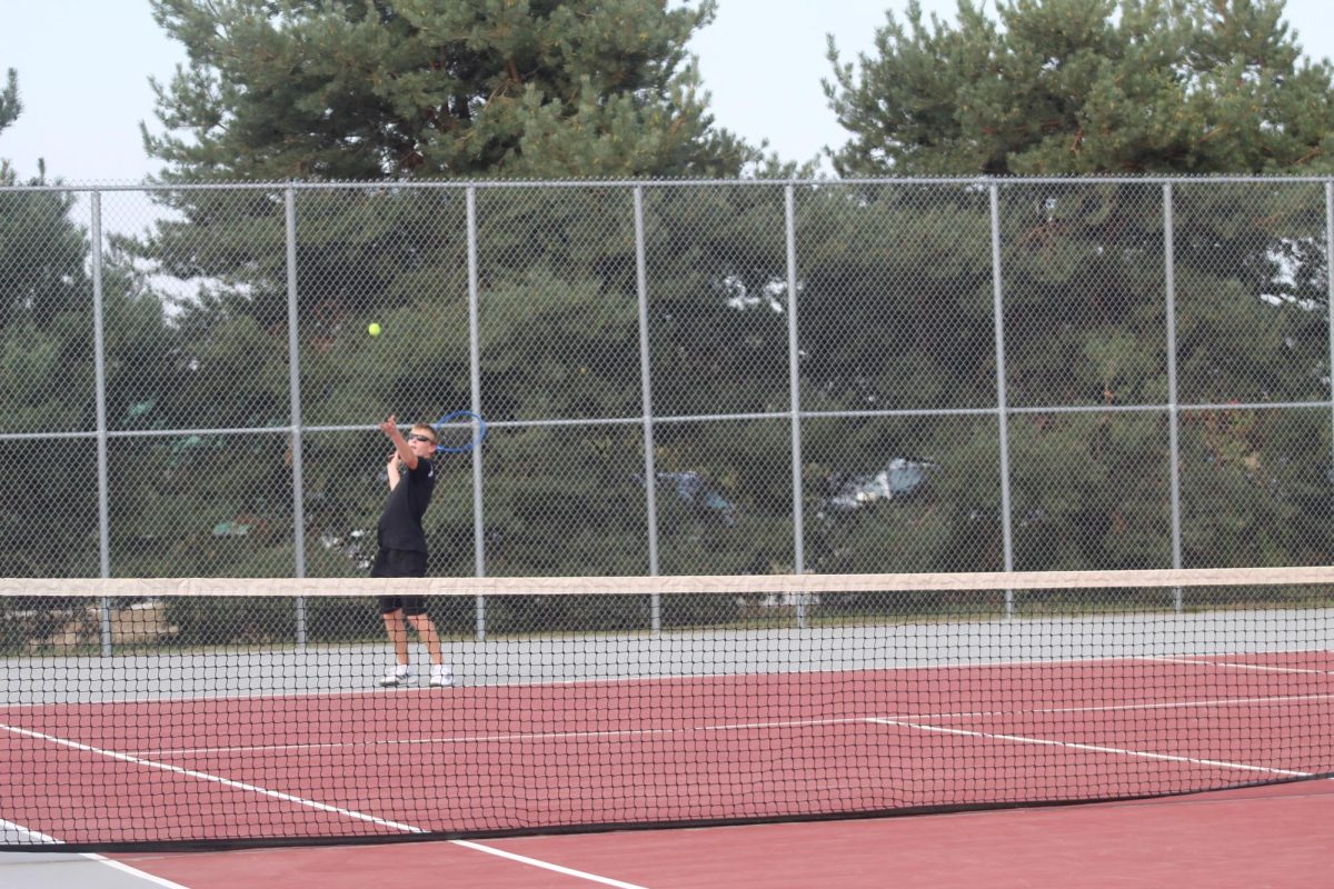 Senior, Luke Bartlett, serving the ball.