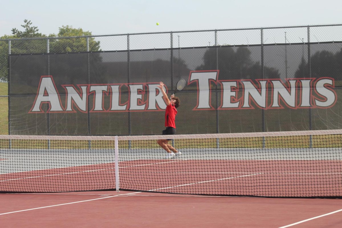 Senior, Jack Fry, serving the ball. 