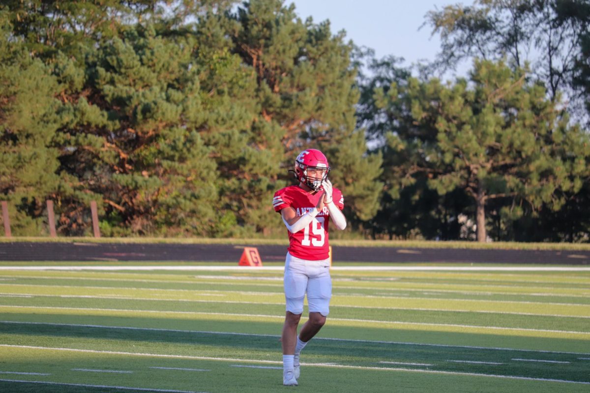 Number 19 Josh Ludacka claps for his team after yet another touchdown. This took place on September 3rd during the JV Antlers vs. Blair game. 