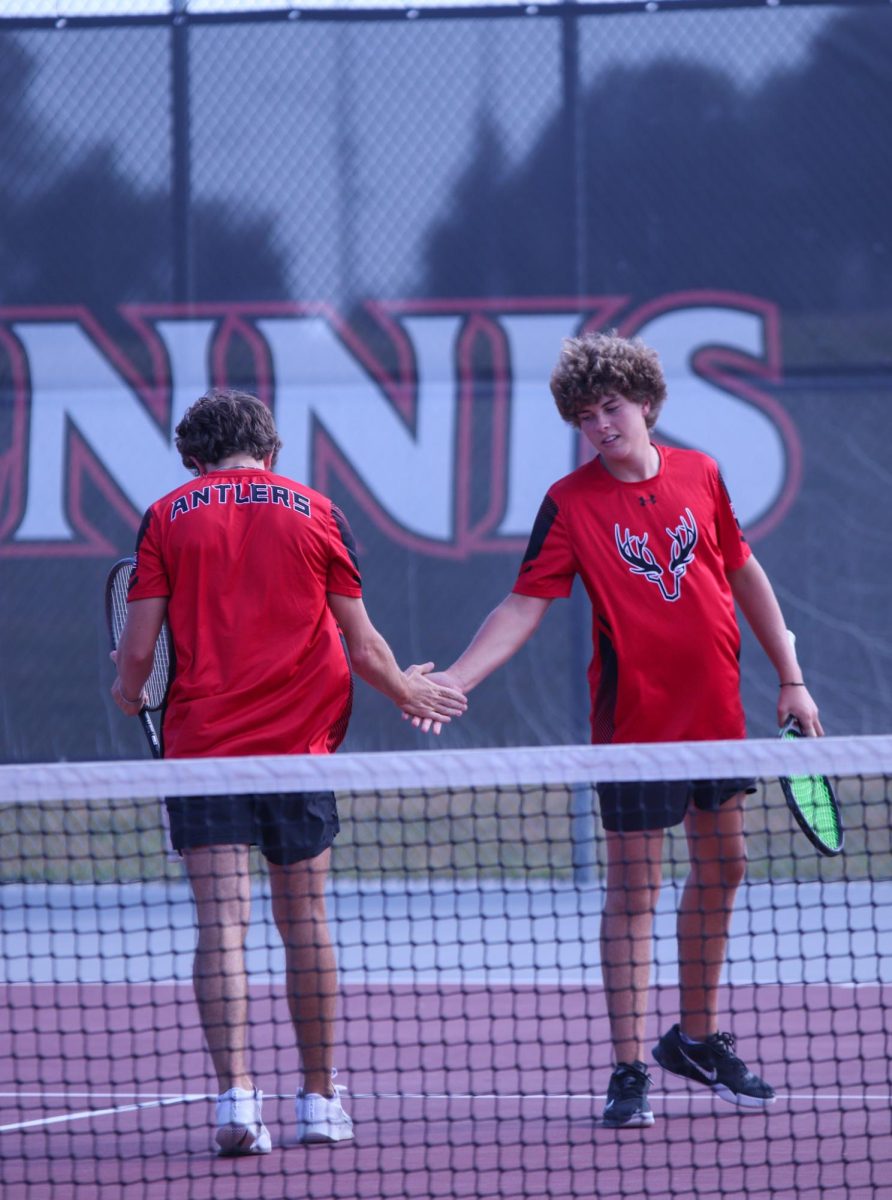 Seniors, Jack Fry and Brody Brummer high five after winning the rally. 