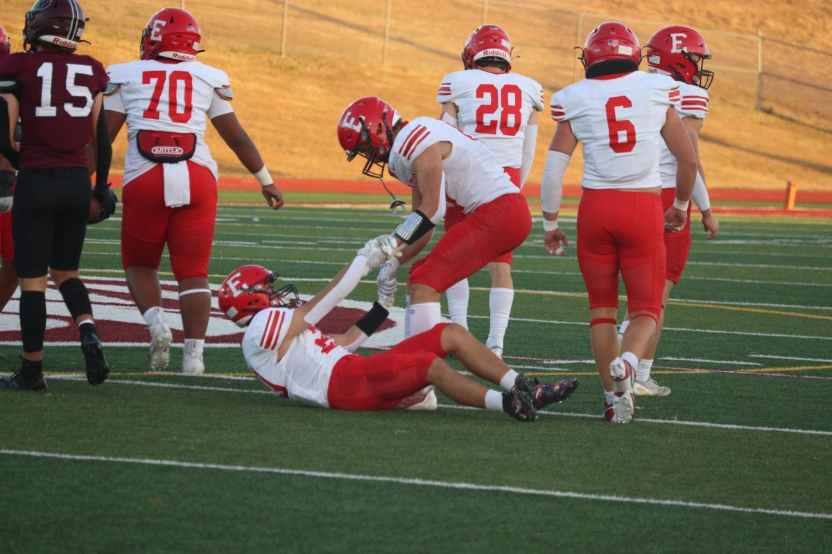 Senior Charlie Lamski helping Gus Schultz up after a play. The final score was 0-28 Waverly on Friday September 20th.