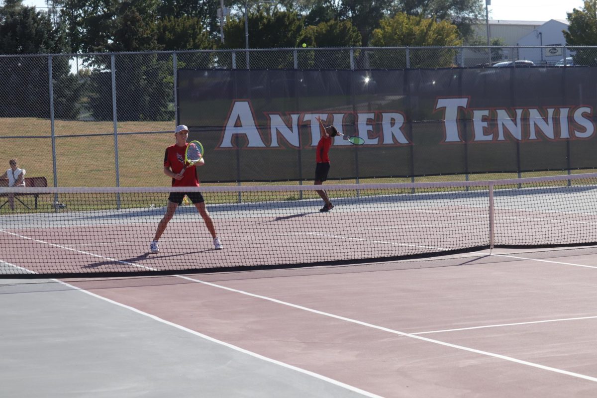 Senior, Deshawn Striplin, serving the ball.