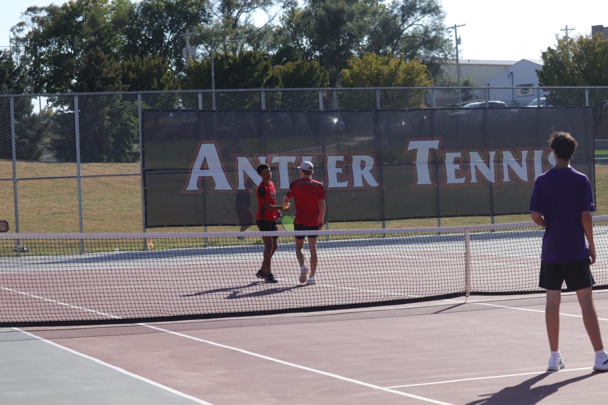 Seniors, Deshawn Striplin and Max Beard, getting ready to serve after receiving a point.