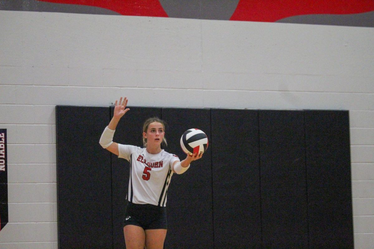 Senior Lauren Fast focuses in as she serves the ball. This took place during the varsity game on 8/29 against Elkhorn North High School. 