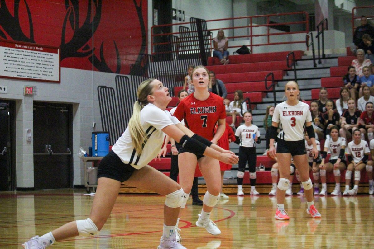 Senior Ava McCasslin watches the ball as she prepares to pass it. This took place during the varsity game on 8/29 against Elkhorn North High School. 