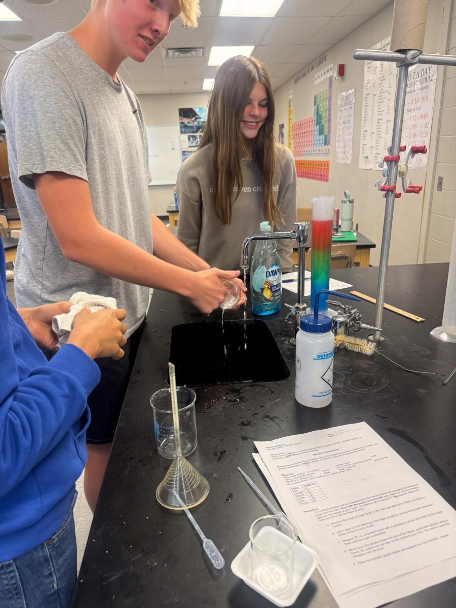 Freshmen group from Mr. Stednitz class rinse their lab equipment after finishing their lab.