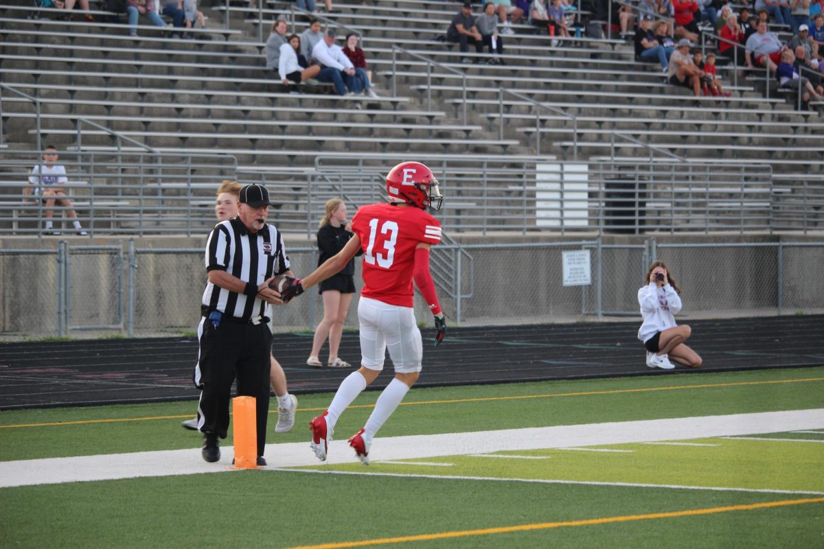 Mathew Ott scores a touchdown and hands the ball to the referee. JV football beat Blair 21-0 on 9/3.