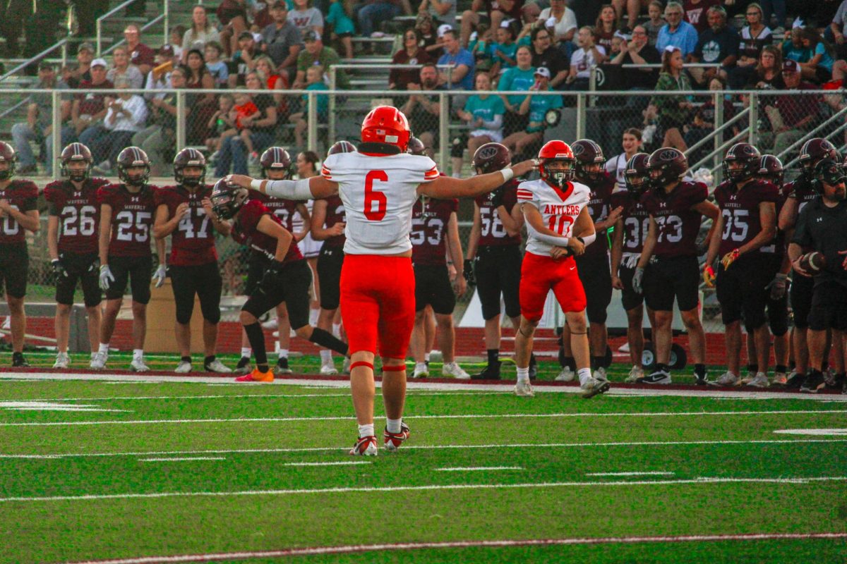 Beckett Mull signals the safe sign after a defensive stop. The Antlers lost to Waverly 28-0 September 20th.