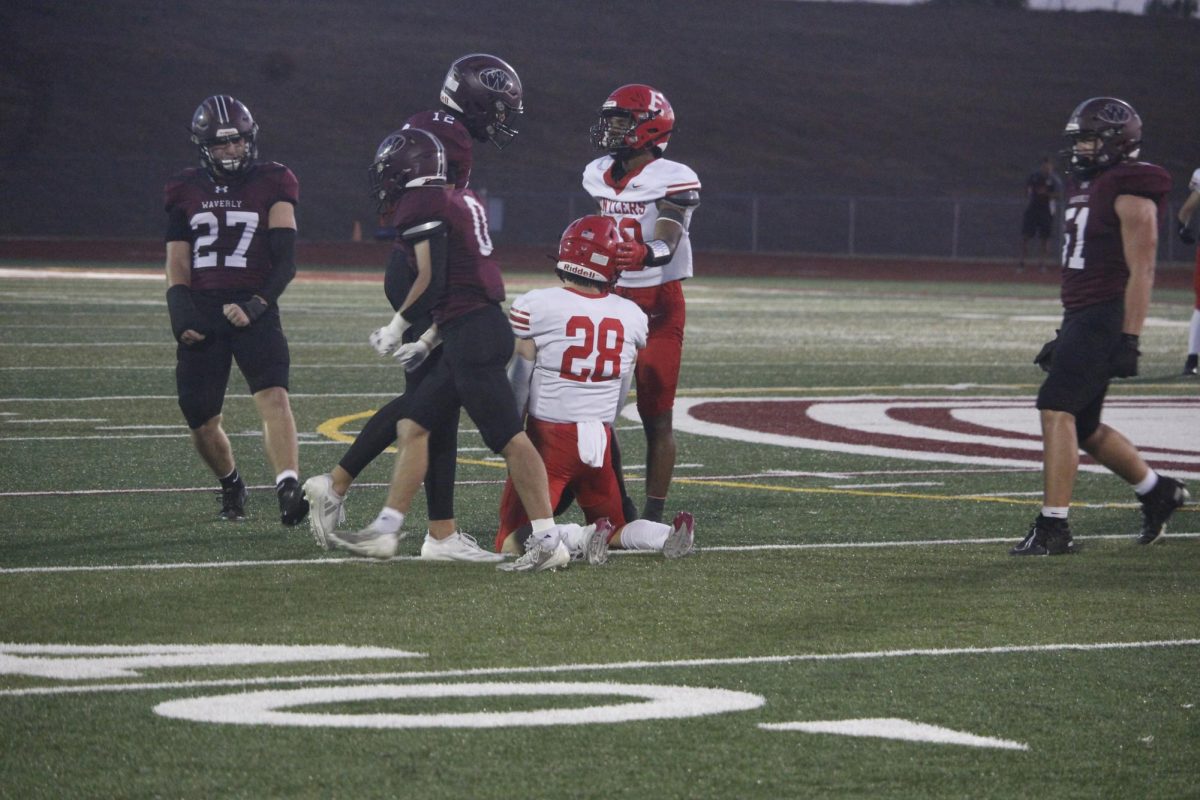 Elliot Beister is on his knees with disappointment after a play against Waverly. The varsity football game was on September 20th with a ending score of 0-28 Waverly. 