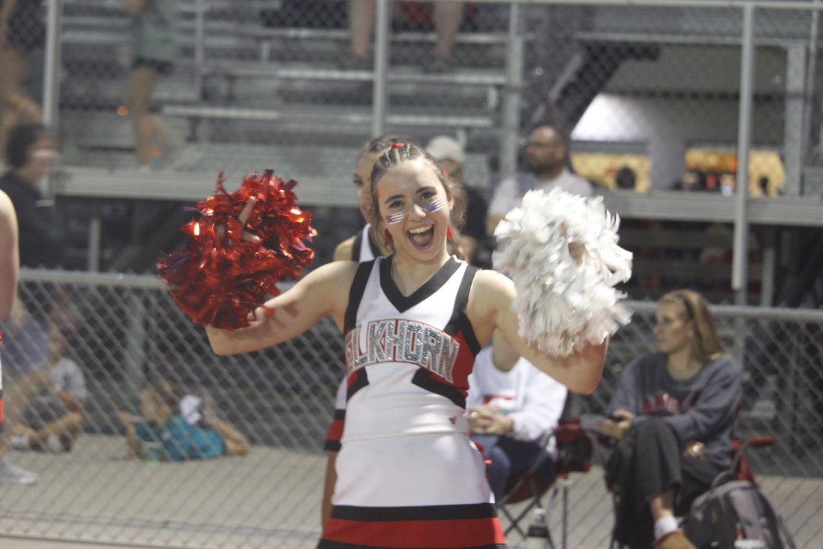 Abbie Schiefelbein is cheering on the sidelines with excitement. The varsity football game was on September 20th with a ending score of 0-28 Waverly. 