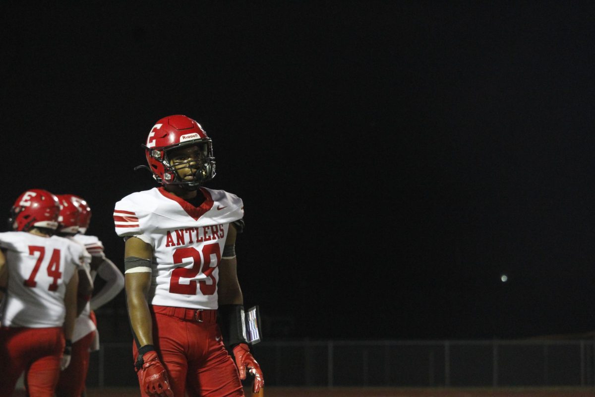 Senior Jayden Moody stands on the field waiting for the next play to happen. The varsity football game was on September 20th with a ending score of 0-28 Waverly. 