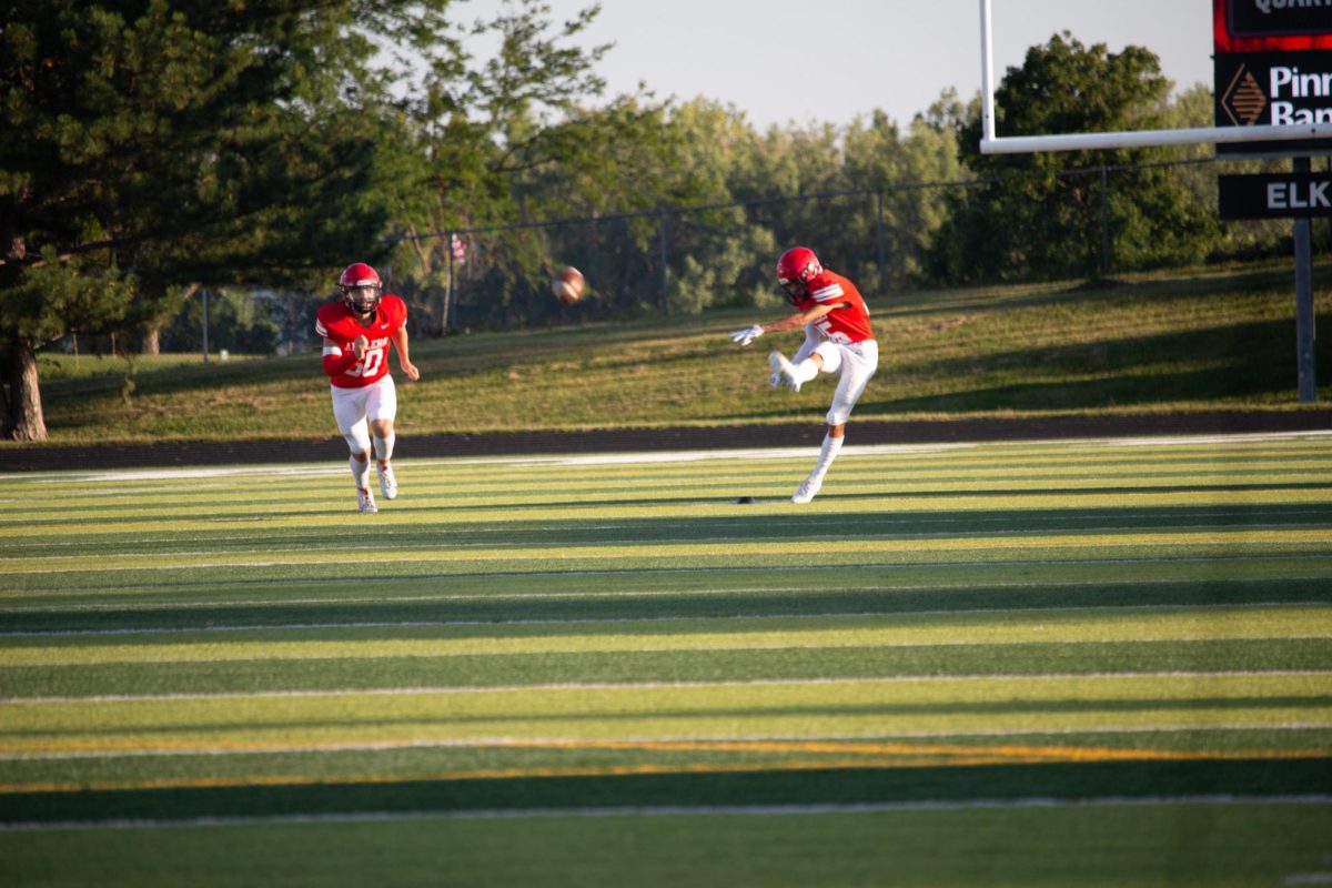 Sophomore Cooper Sutton punts the ball. JV football beat Blair 21-0 on 9/3 2024.