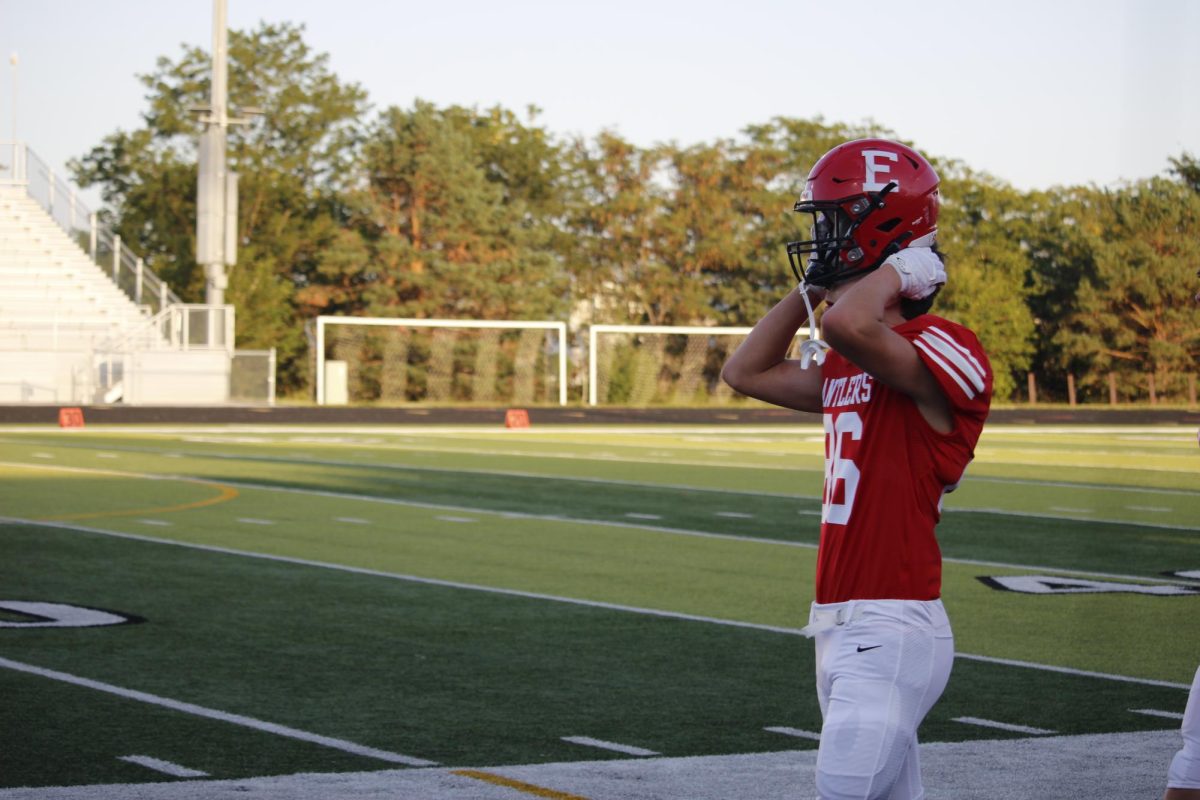 Sophomore Brady Mataele puts on his helmet preparing to go back on the field. JV football beat Blair 21-0 on 9/3.