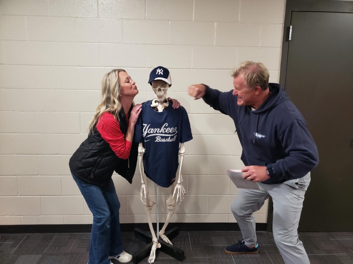 Spanish teacher Christine Schultz displays her affection for the Yankees as journalism teacher Chris Jenson shows his dislike. Science teacher Connie Bang displayed her Hideki Matsui Bang skeleton to celebrate the start of the World Series.
Photo courtesy of Connie Bang