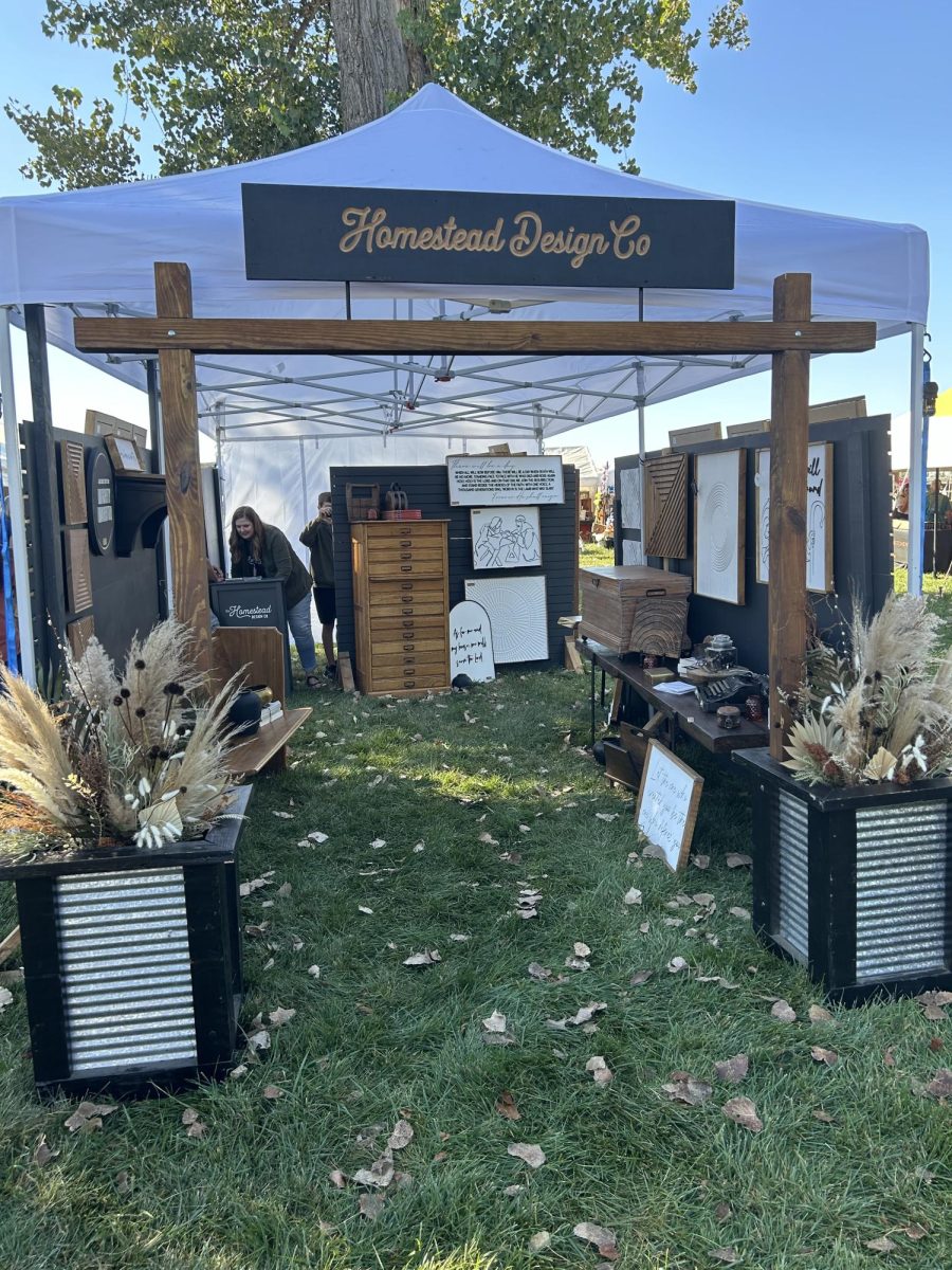 This is a stand in the open area around the barn, this stand has homemade home decor. This was at Junkstock Friday 9/27/24. 