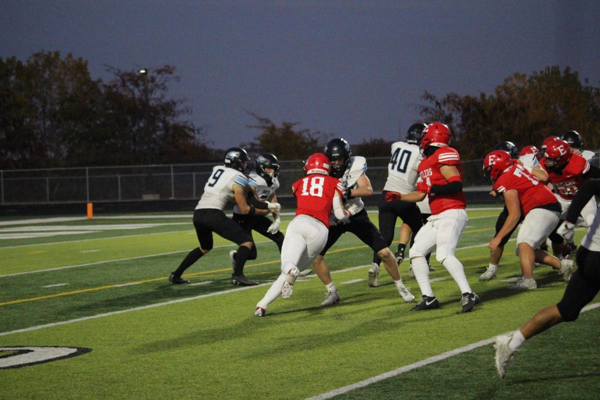 Junior, Jack Metschke pushing against Elkhorn North