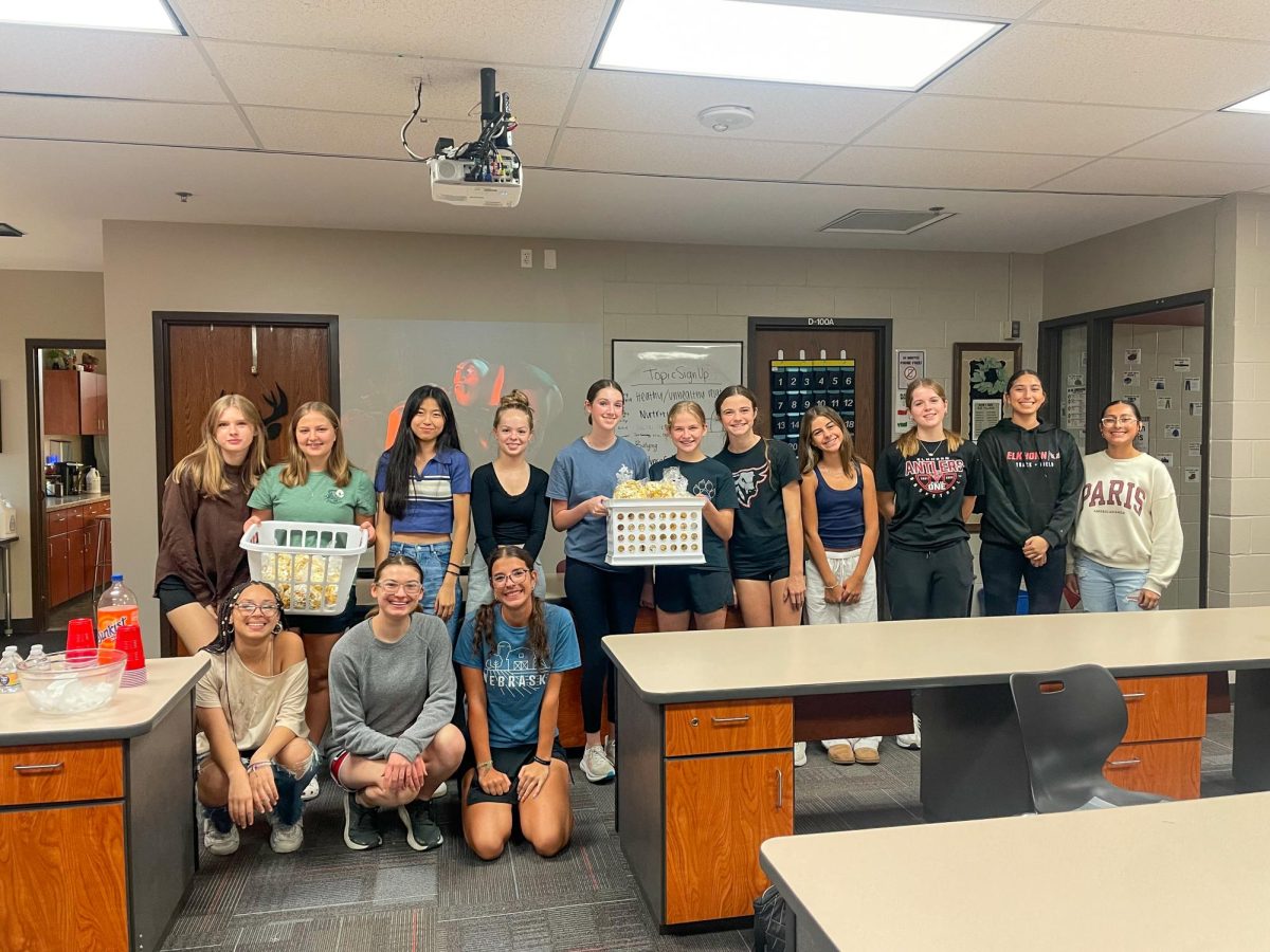 FCCLA members make popcorn bags for teachers while enjoying a movie night social.